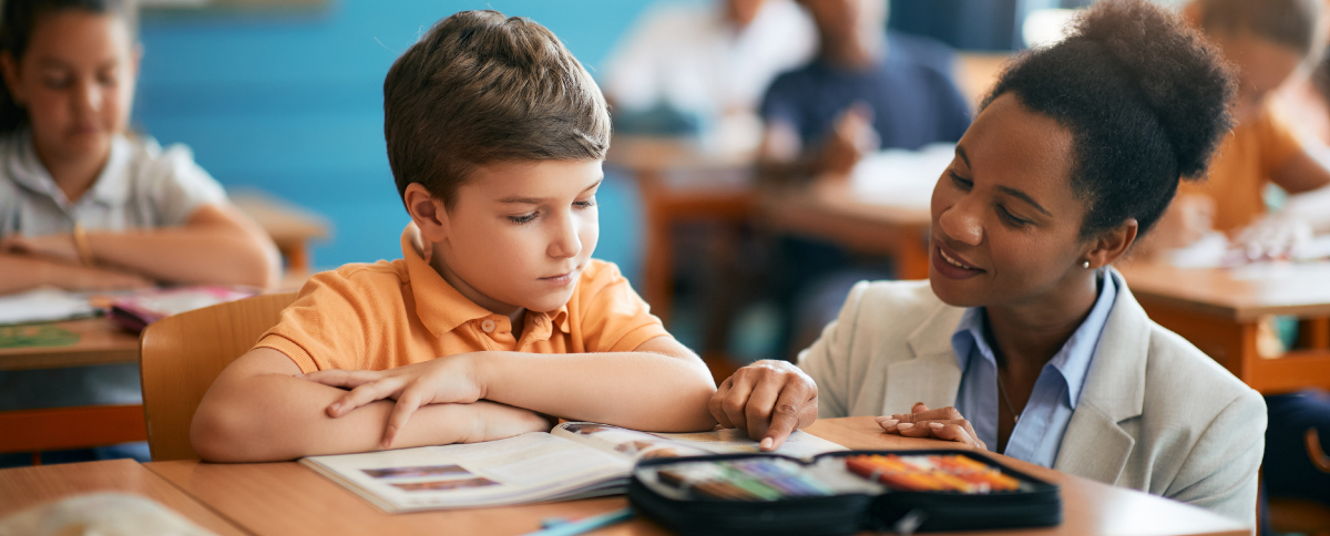 Teacher helping a student in the classroom.